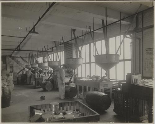 Employee overseeing gravity paint filler machines