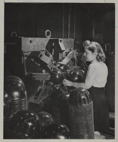 Woman making helmet liners