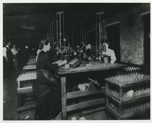 Workers assembling light bulbs