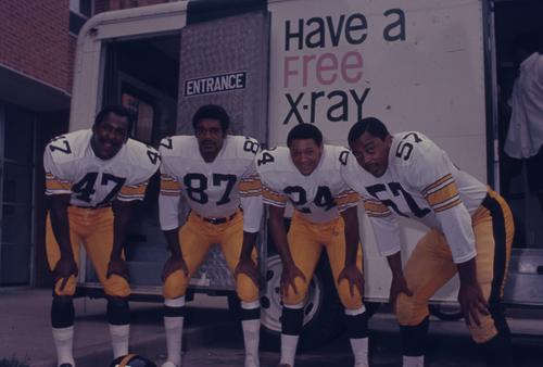 Pittsburgh Steeler football players outside mobile x-ray unit