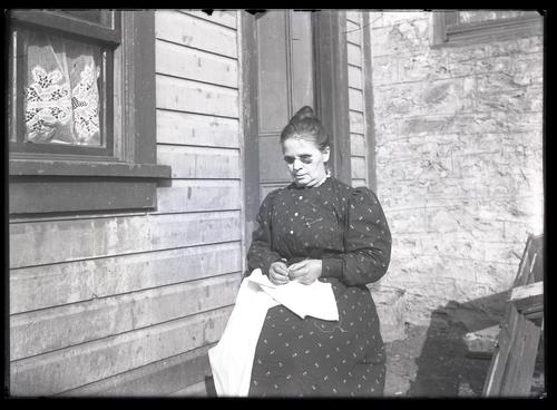 Blind woman sewing by hand