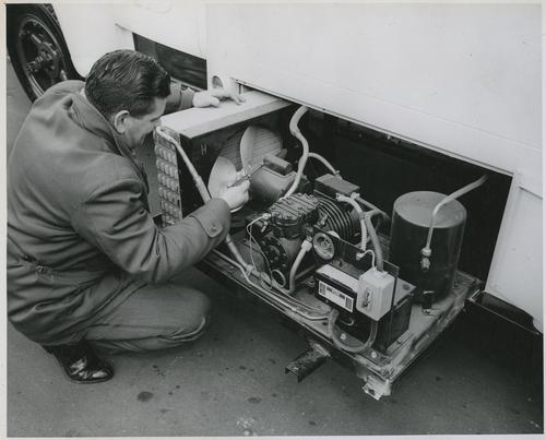 Employee Inspecting Refrigeration Motor