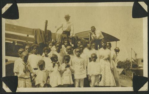 Family and friends gathered around lumber truck