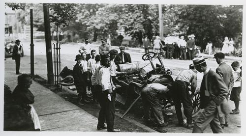 Crowds Around Damaged Vehicles