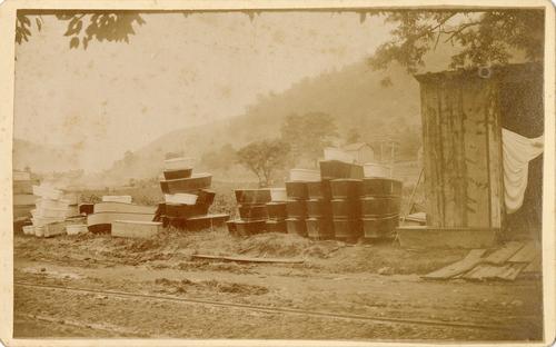 Caskets piled near rail siding