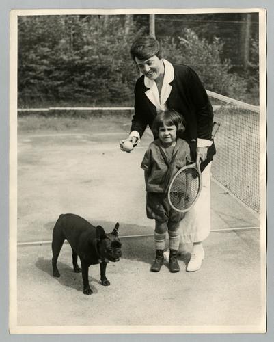 Mary Roberts Rinehart on tennis court with unidentified child