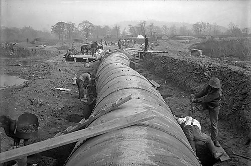 Men Working Around Pipe