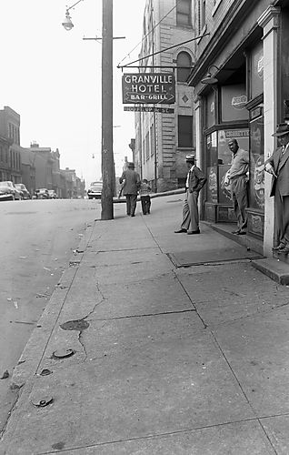 Man Standing Near A Storefront