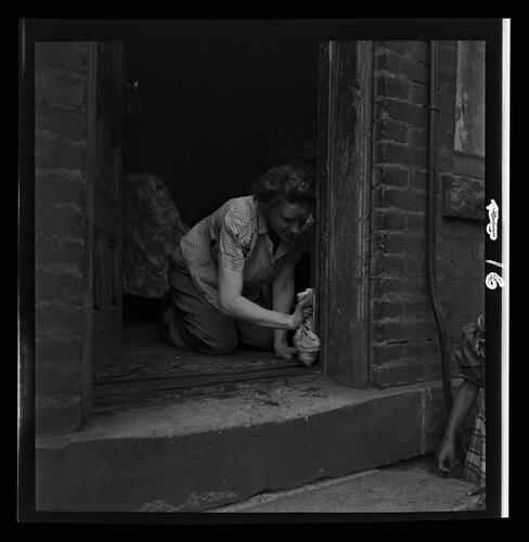 Woman Cleaning Doorway