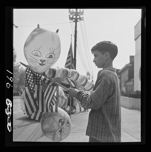 Boy with Flags and Balloons on Penn Avenue