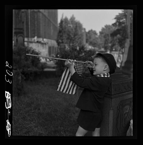 Boy Playing with Flag in Cemetery