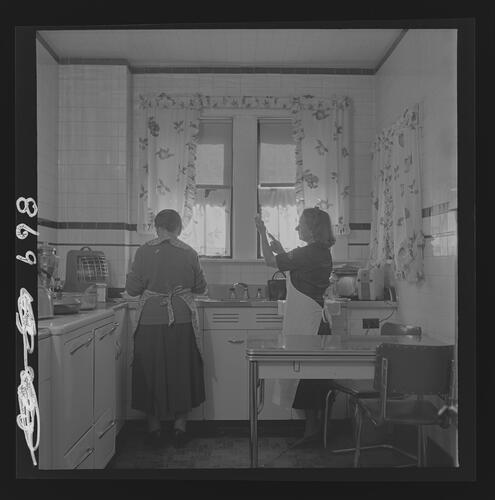 Woman and Nurse in Kitchen