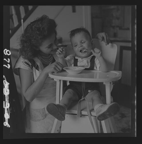 Child in High Chair and Woman in Home