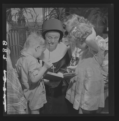Nun Reading to Children