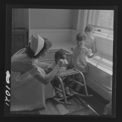 Nurse Helping Child Drink