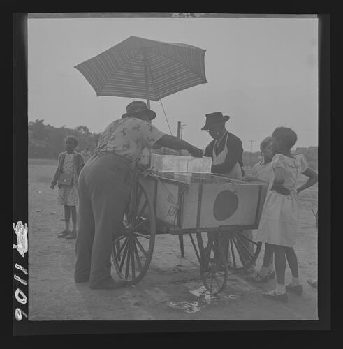 Man Selling Shaved Ice from Cart