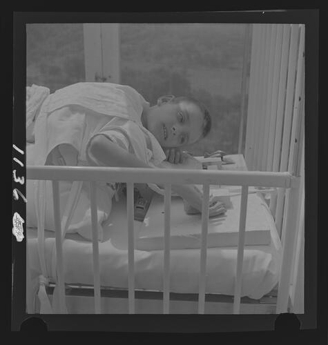 Child Playing with Toys in Bed