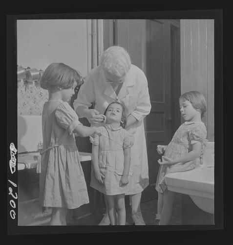 Nuse Washing Child's Face