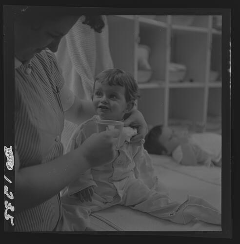 Nurse Helping Child Drink