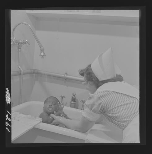 Nurse Bathing Child