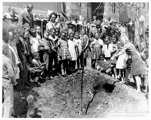 Miller School students plant a tree at the Wylie Avenue Library