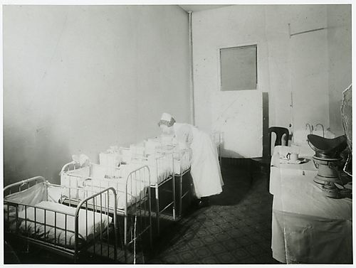 Nurse caring for infants in nursery