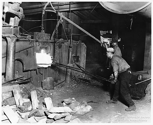 Puddlers removing a ball from an Iron Puddling Furnace