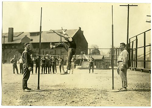 Men practicing the high jump in Washington Park