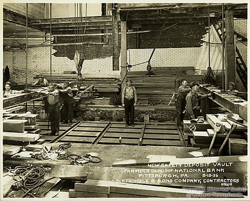 Workers constructing safety deposit vault at the Farmers Deposit Bank