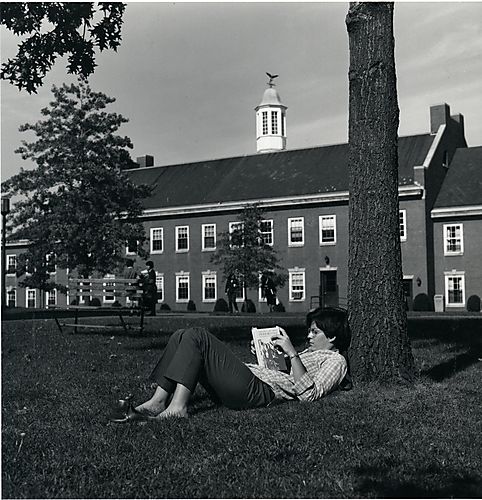 Student Reading on Campus Green