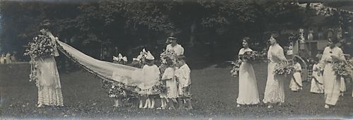 May Queen Melba R. Martin leads children's escort and attendants