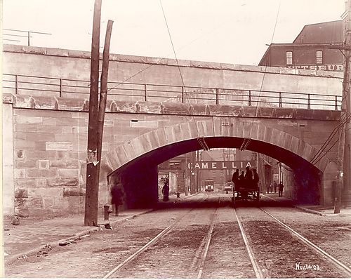 Close-up - street car, and horse drawn carriage